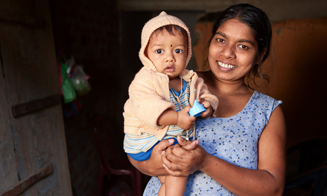 photo of mother holding baby